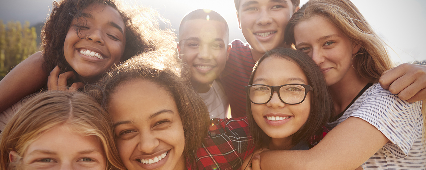 A group of friends smiling and huddled together
